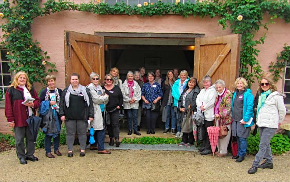 EWHA members standing in front of a doorway