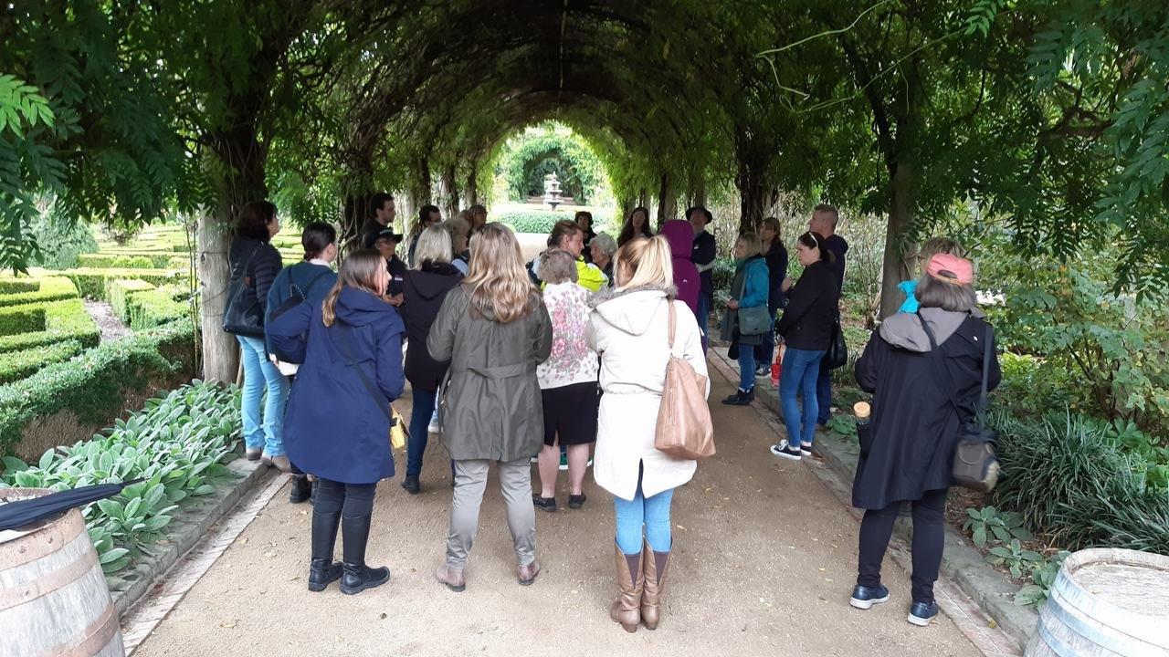 People standing under the grand Wisteria Archway 