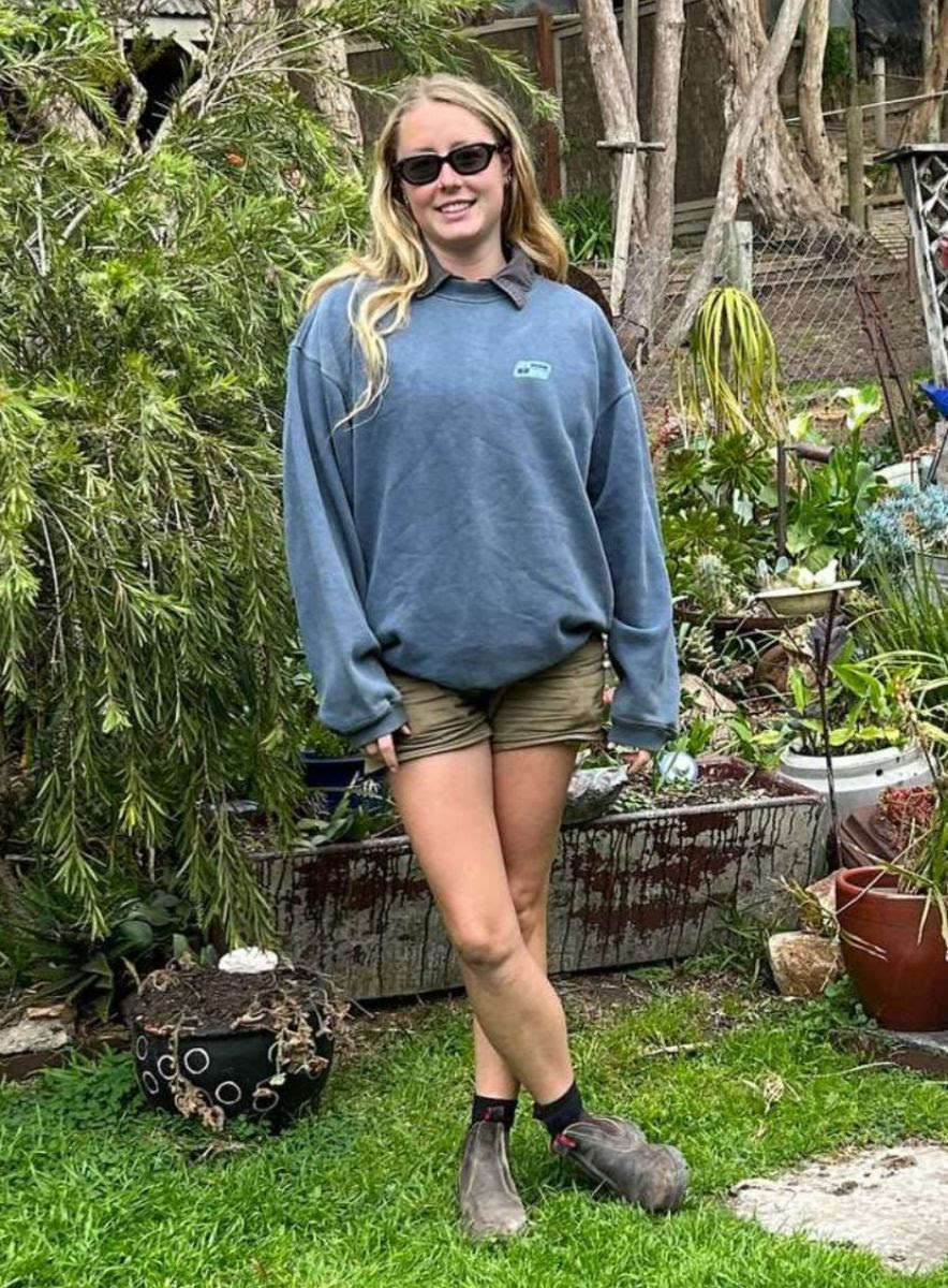 Izabella stands in her garden