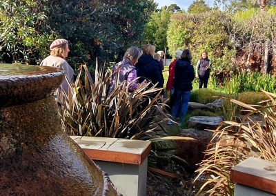 Lubana guiding EWHA members and non-members around a private garden in Balnarring.