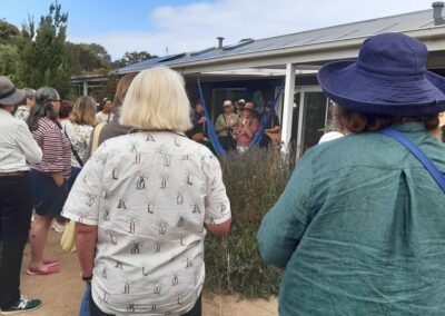 Group of women standing on and around the back porch of an Australian home.