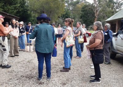 Group of women standing in a nursery listening to a speaker.