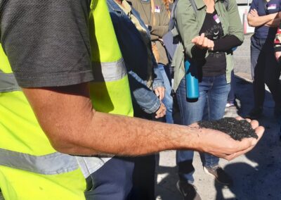 Person holding a handful of biochar.
