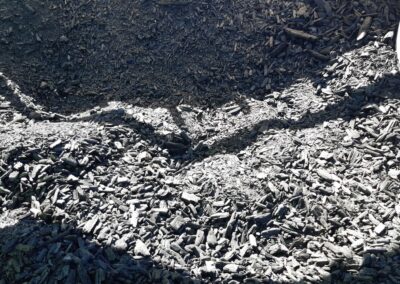Close up of biochar. It is black and small gritty pieces.