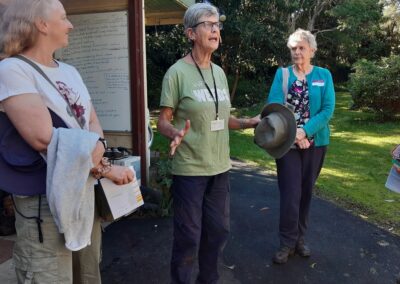 Speaker and people listening at a talk outdoors.