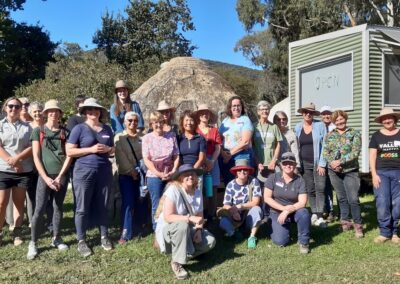 Large group photo of women taken outdoors.