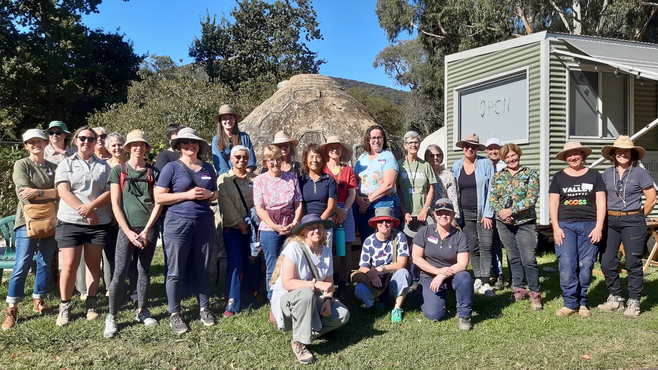 Large group photo of women taken outdoors.