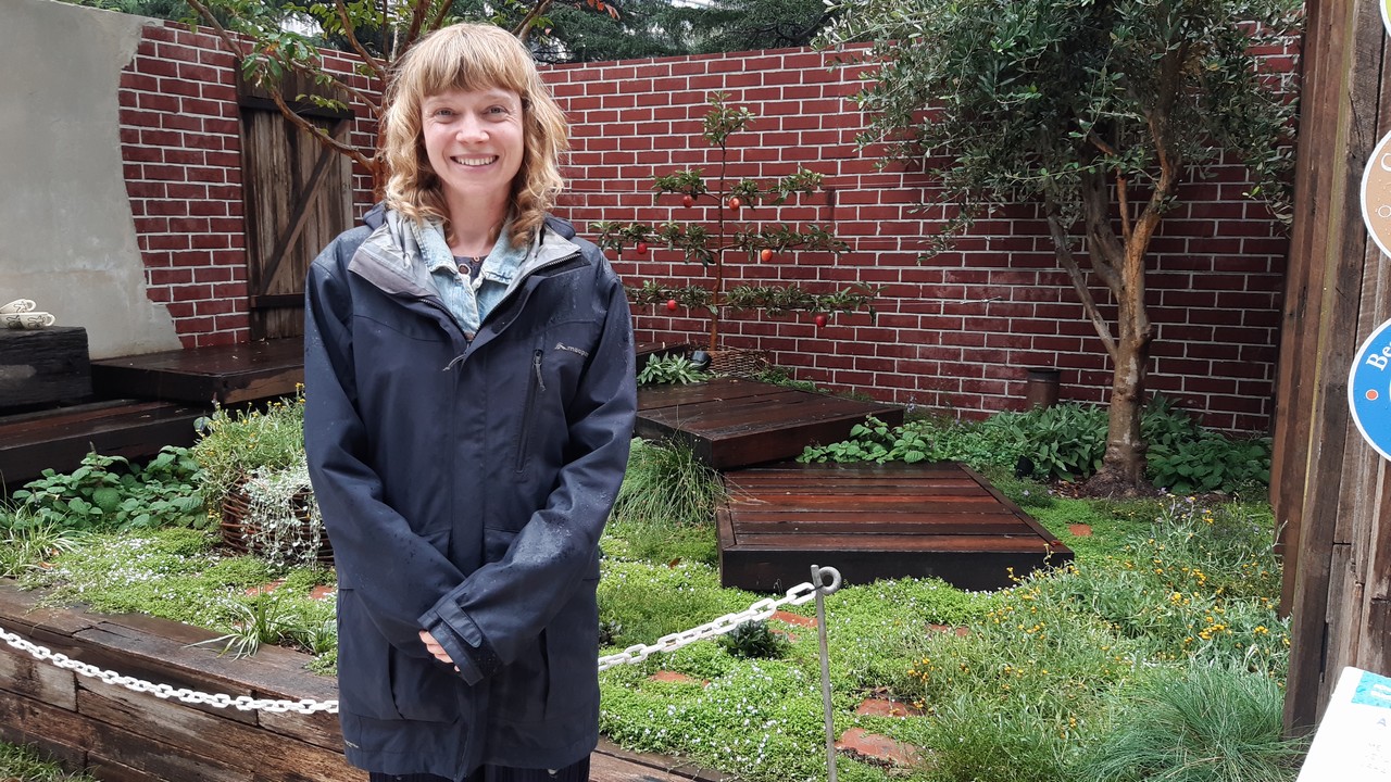 Woman standing in a display garden.