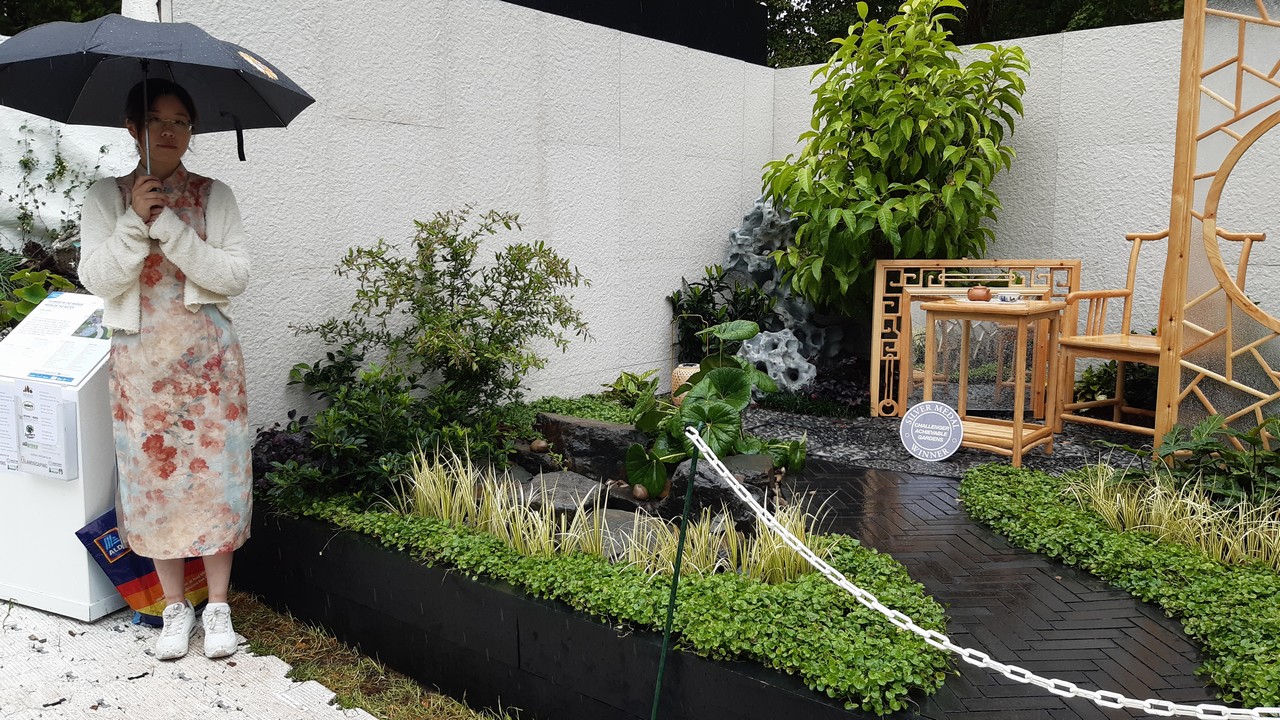 Woman standing in a display garden.