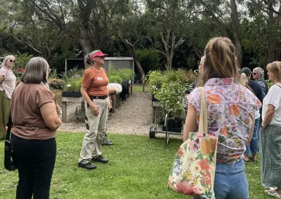 Group of women standing in a nursery listening to a speaker.